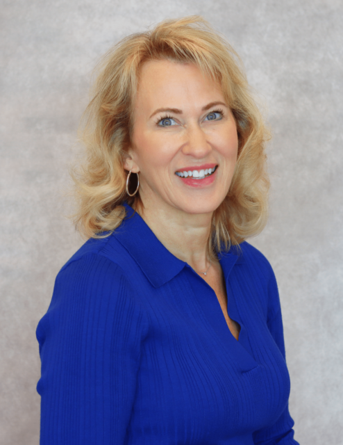 Julie Hammond, APRN-C, smiling in a blue blouse with a neutral background.