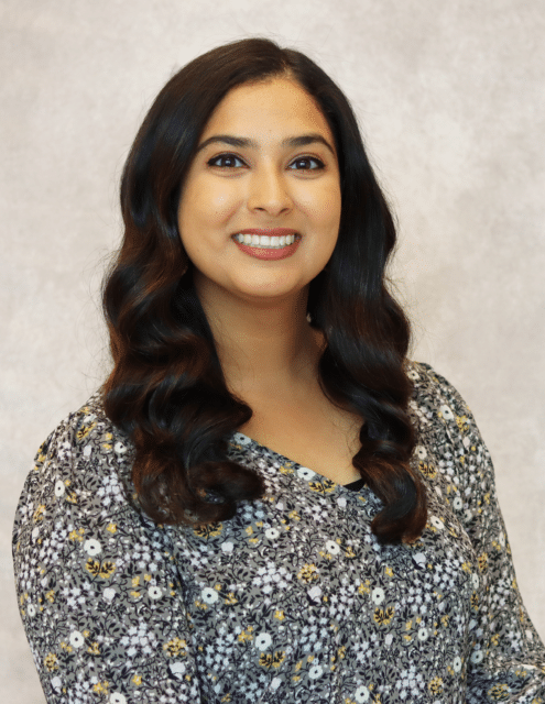 Beejal Vadhar, APRN-C, smiling in a floral blouse against a neutral background.