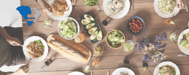 a dinner table set with several healthy, green dishes