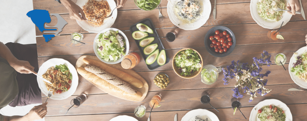 a dinner table set with several healthy, green dishes